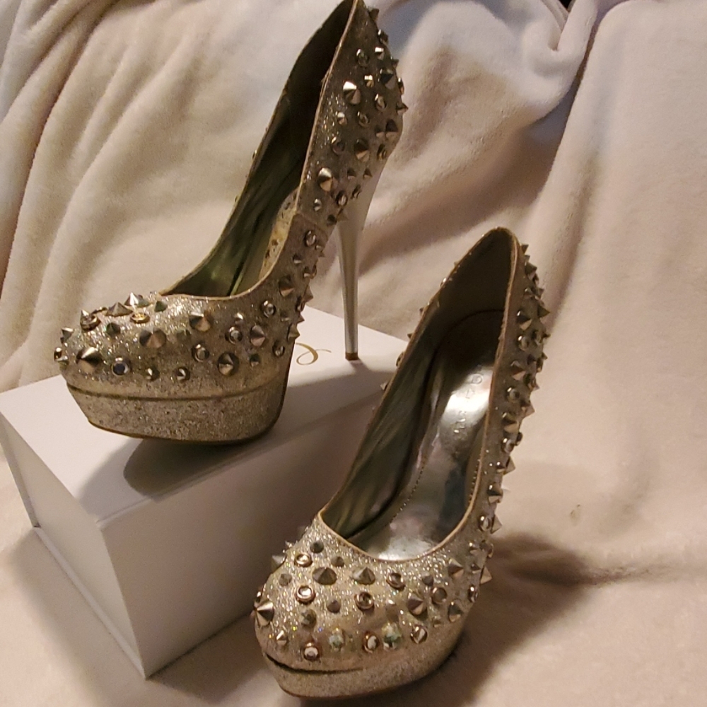Gold fish, shiny silver shoes with spikes.